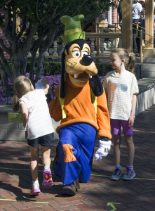 Goofy has some fun with some younger guests at Disneyland near City Hall.