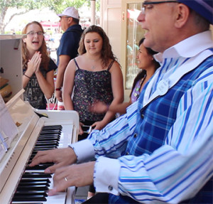 These three girls sang an impromptu performance of "Let It Go" from the Walt Disney Animation film "Frozen" at Disneyland's Coke Corner with the Ragtime Pianist.