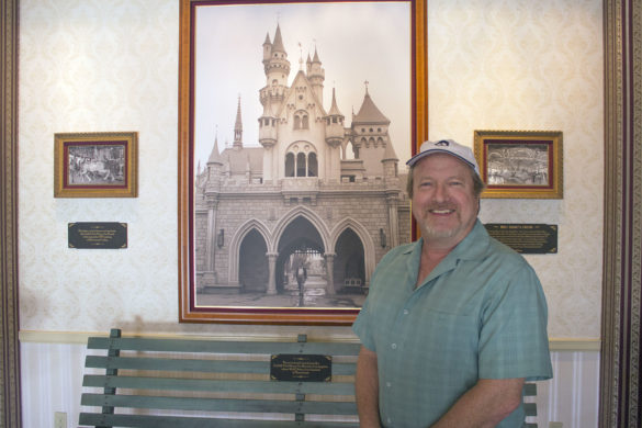 Scott Zone, the official archivist of the Disney family home movies, stands in front of a bench from Griffith Park at Disneyland.