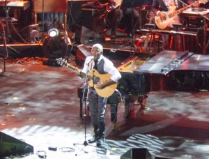 Jonathan Butler plays his guitar and sings for the audience at the Yamaha NAMM 2015 concert.